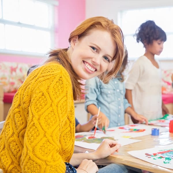 a little girl sitting at a table